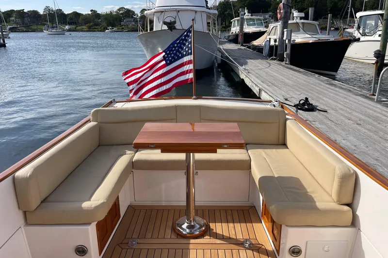 Sea Glass Yacht Photos Pics 2015 CH Marine Shelter Island Runabout with American flag, docked at marina.