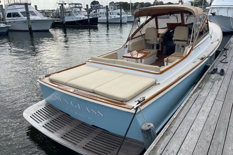 Sea Glass Yacht Photos Pics 2015 CH Marine Shelter Island Runabout docked, featuring elegant seating and classic design.