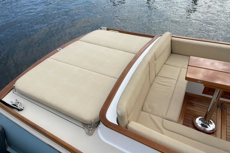 Sea Glass Yacht Photos Pics 2015 CH Marine Shelter Island Runabout with beige seating and wooden table on water.