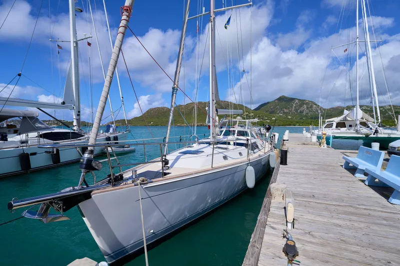 Cinchona Yacht Photos Pics Sailboat docked at marina, Outbound 52 model, 2020, with scenic mountain backdrop.