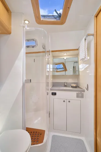 Cinchona Yacht Photos Pics Modern bathroom in 2020 Outbound 52 yacht with shower, skylight, and sleek cabinetry.