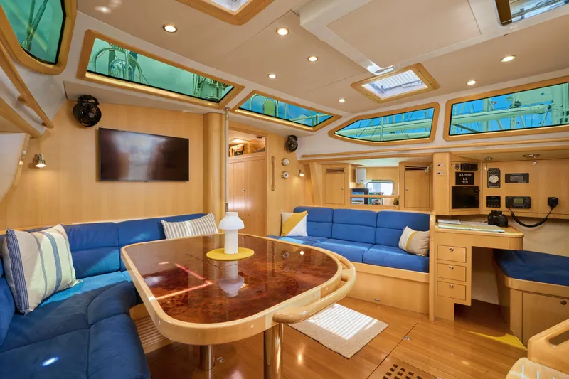 Cinchona Yacht Photos Pics Luxurious interior of 2020 Outbound 52 yacht with blue seating and wooden accents.