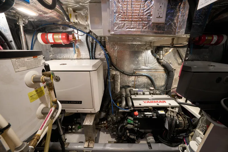 Cinchona Yacht Photos Pics Engine room of 2020 Outbound 52 yacht with Yanmar engine and fire safety equipment.