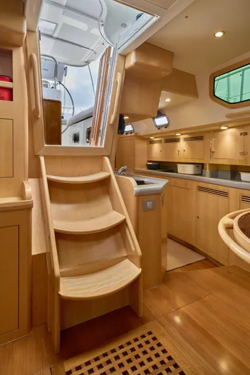 Cinchona Yacht Photos Pics Luxurious 2020 Outbound 52 yacht interior with wooden stairs and modern kitchen.
