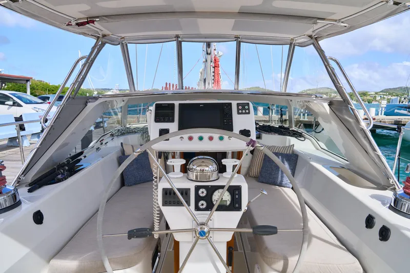 Cinchona Yacht Photos Pics Cockpit of 2020 Outbound 52 yacht with steering wheel and navigation controls.