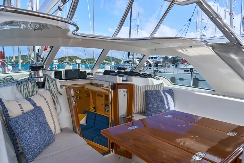Cinchona Yacht Photos Pics Luxurious interior of 2020 Outbound 52 yacht with plush seating and wooden table.