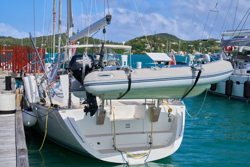 Cinchona Yacht Photos Pics Sailboat Outbound 52, 2020 model, docked with dinghy, in a marina setting.