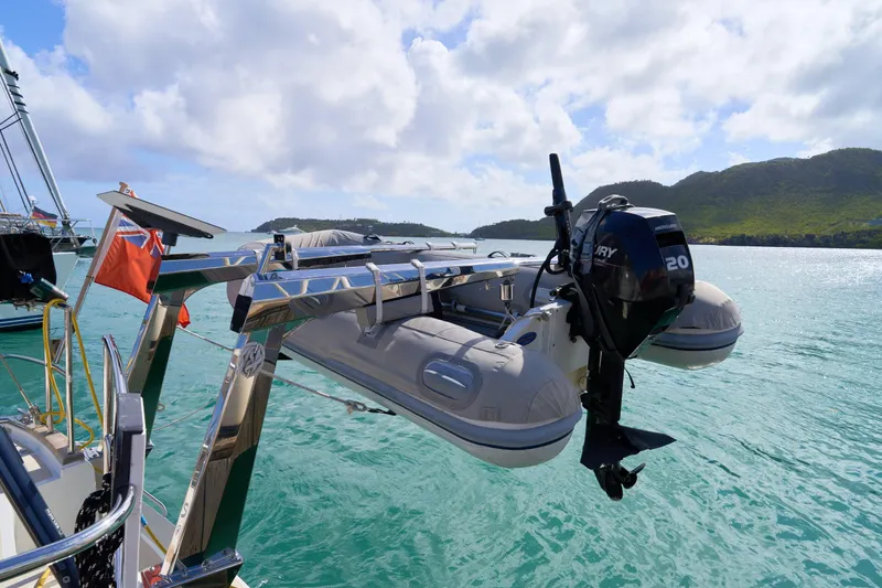 Cinchona Yacht Photos Pics Inflatable boat with outboard motor on Outbound 52 yacht, 2020, in scenic coastal waters.