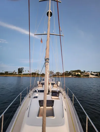 Cinchona Yacht Photos Pics Outbound 52 sailboat from 2020 on calm water, clear sky, coastal background.