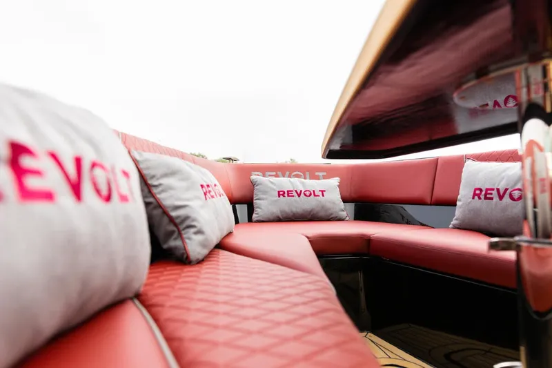  Yacht Photos Pics Luxurious interior of 2023 Revolt Comfort 47 boat with red seating and branded cushions.