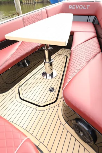  Yacht Photos Pics Luxurious 2023 Revolt Comfort 47 boat interior with red seating and elegant wood flooring.