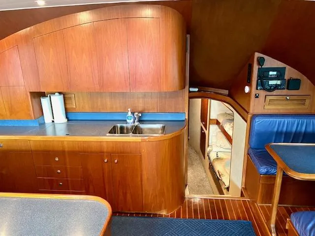 Woodcutter Yacht Photos Pics Luxurious 2000 Custom Carolina 56 East Bay yacht interior with wood cabinetry and cozy seating.