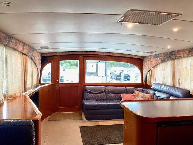 Woodcutter Yacht Photos Pics Interior of 2000 Custom Carolina 56 East Bay yacht with leather seating and wood accents.