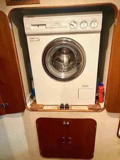 Woodcutter Yacht Photos Pics Compact washing machine in a 2000 Custom Carolina 56 East Bay boat interior.