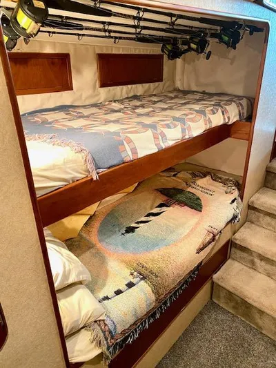 Woodcutter Yacht Photos Pics Bunk beds with fishing rods in a 2000 Custom Carolina 56 East Bay boat cabin.
