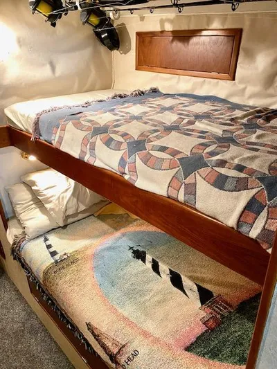 Woodcutter Yacht Photos Pics Bunk beds with patterned quilts in a 2000 Custom Carolina 56 East Bay yacht cabin.