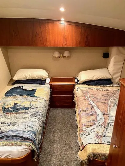 Woodcutter Yacht Photos Pics Twin beds in a 2000 Custom Carolina 56 East Bay cabin with nautical-themed blankets.