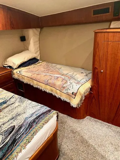 Woodcutter Yacht Photos Pics Cozy cabin interior of 2000 Custom Carolina 56 East Bay with twin beds and wooden cabinetry.