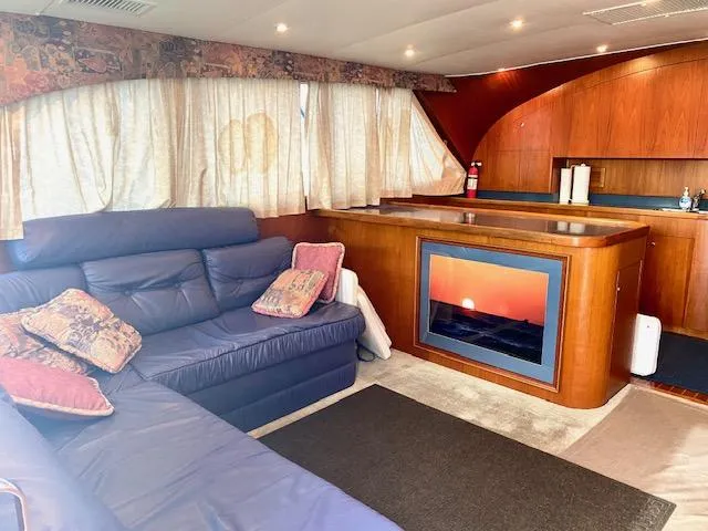 Woodcutter Yacht Photos Pics Luxurious interior of 2000 Custom Carolina 56 East Bay yacht with cozy seating and elegant wood finishes.