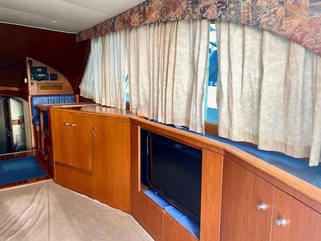 Woodcutter Yacht Photos Pics Interior of 2000 Custom Carolina 56 East Bay yacht with wood cabinetry and curtains.