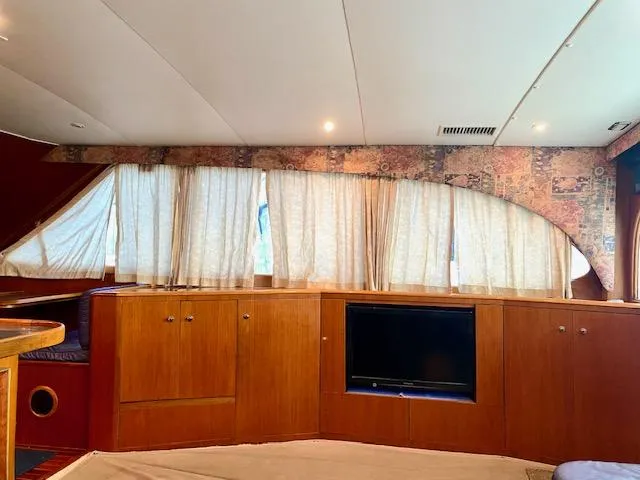 Woodcutter Yacht Photos Pics Interior of 2000 Custom Carolina 56 East Bay yacht with wood cabinets and TV.