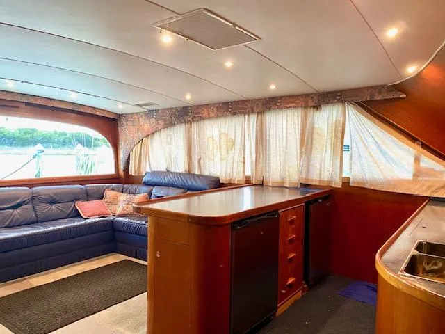 Woodcutter Yacht Photos Pics Interior of 2000 Custom Carolina 56 East Bay yacht with cozy seating and kitchenette.