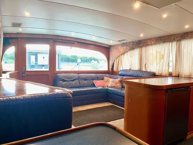 Woodcutter Yacht Photos Pics Luxurious interior of 2000 Custom Carolina 56 East Bay yacht with leather seating and wood accents.