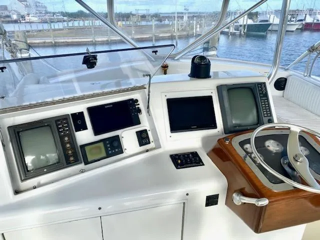 Woodcutter Yacht Photos Pics Custom Carolina 56 East Bay 2000 yacht helm with navigation equipment and steering wheel.