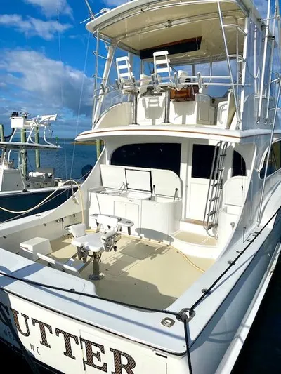 Woodcutter Yacht Photos Pics Custom Carolina 56 East Bay 2000 yacht with spacious deck and seating, docked under blue skies.