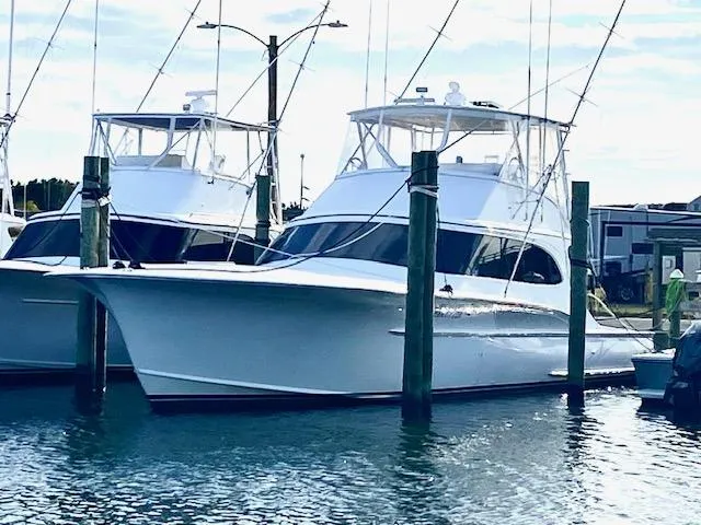 Woodcutter Yacht Photos Pics Custom Carolina 56 East Bay 2000 yacht docked at marina, clear sky background.