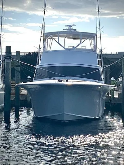 Woodcutter Yacht Photos Pics Custom Carolina 56 East Bay 2000 yacht docked, reflecting sunlight on water.