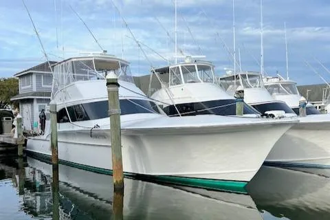 Woodcutter Yacht Photos Pics Custom Carolina 56 East Bay 2000 yacht docked at marina, clear sky background.
