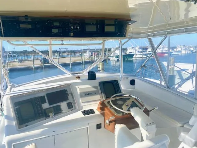 Woodcutter Yacht Photos Pics Custom Carolina 56 East Bay 2000 yacht cockpit with navigation equipment and marina view.