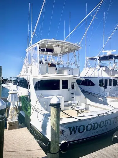 Woodcutter Yacht Photos Pics Custom Carolina 56 East Bay 2000 yacht docked, named "Woodcutter," under clear blue sky.