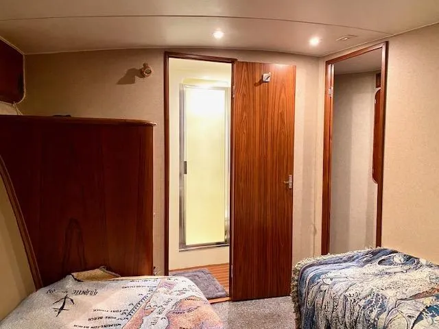 Woodcutter Yacht Photos Pics Cozy cabin interior of 2000 Custom Carolina 56 East Bay yacht with twin beds and wooden accents.