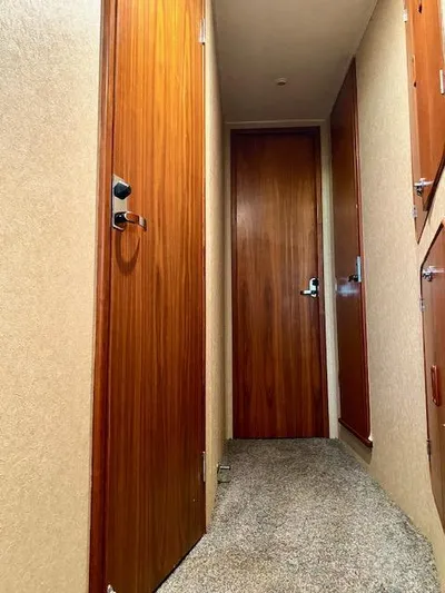 Woodcutter Yacht Photos Pics Interior hallway of 2000 Custom Carolina 56 East Bay yacht with wooden doors.