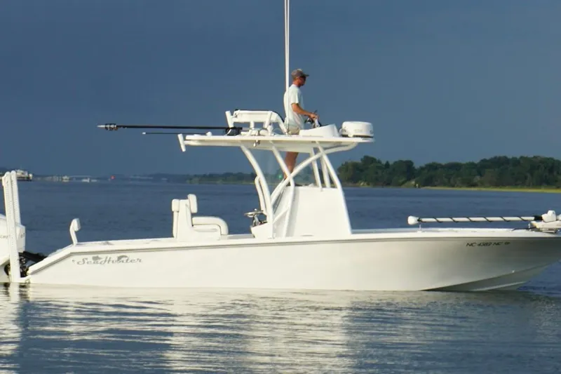  Yacht Photos Pics 2022 SeaHunter 28 Floridian boat on calm water with a person navigating.