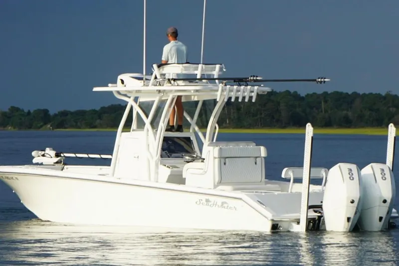  Yacht Photos Pics 2022 SeaHunter 28 Floridian boat on calm water with dual engines and fishing gear.
