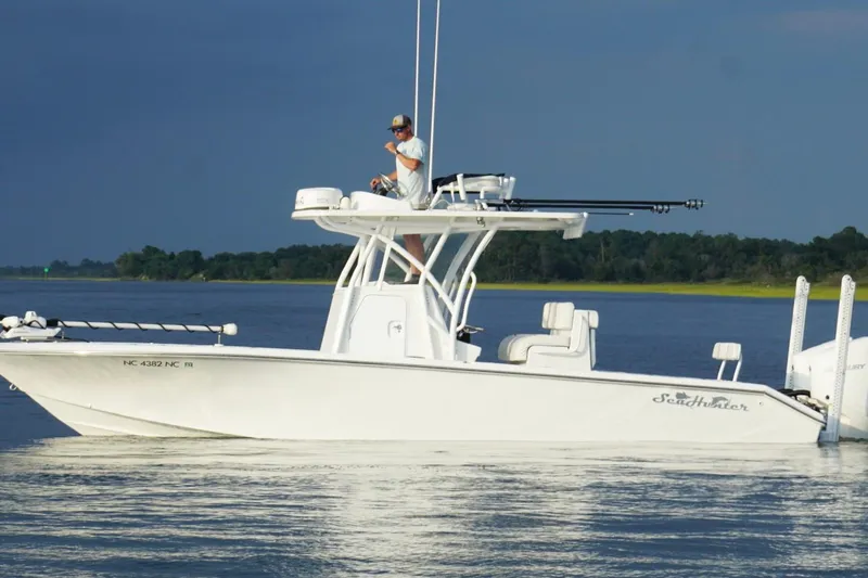  Yacht Photos Pics 2022 SeaHunter 28 Floridian boat on calm water, with person on deck.