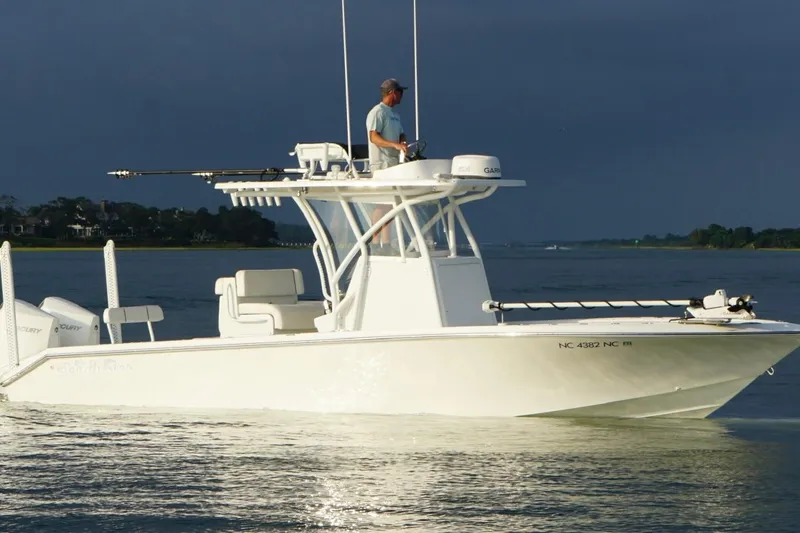  Yacht Photos Pics 2022 SeaHunter 28 Floridian boat on calm water with a person navigating.