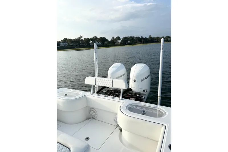  Yacht Photos Pics 2022 SeaHunter 28 Floridian boat with dual Mercury engines on a calm lake.