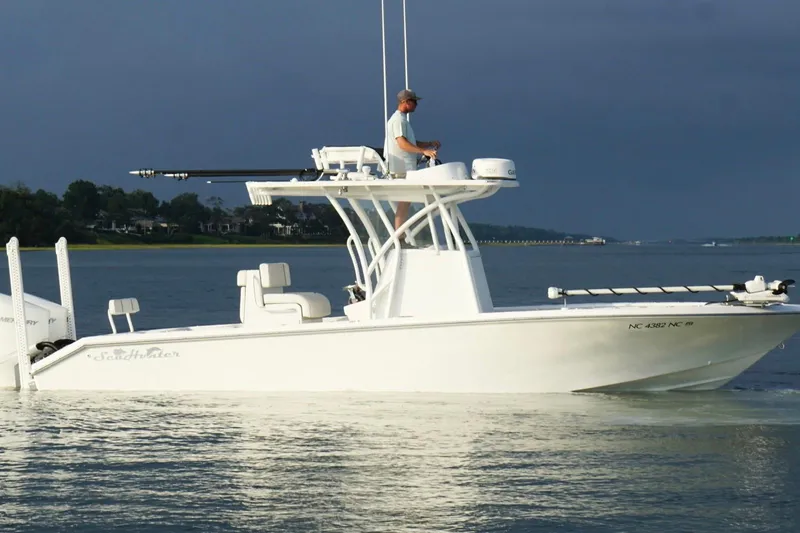  Yacht Photos Pics 2022 SeaHunter 28 Floridian boat on calm water, with a person navigating.