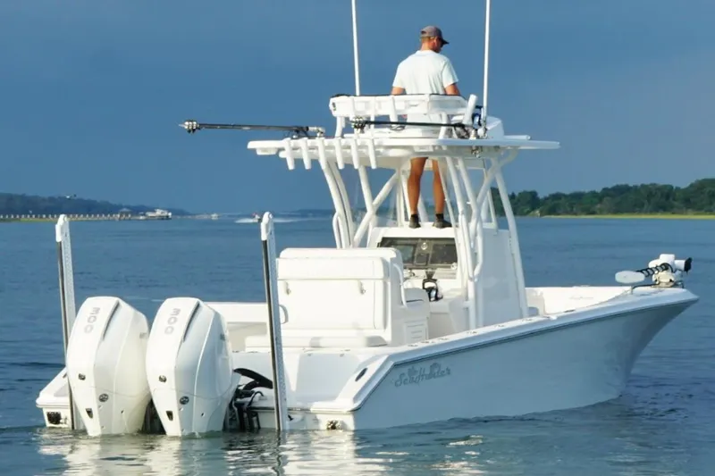  Yacht Photos Pics 2022 SeaHunter 28 Floridian boat on water, featuring dual engines and a person navigating.