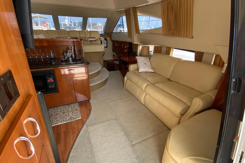 Slippin Out Yacht Photos Pics Luxurious interior of 2004 Carver 36 Super Sport yacht with beige leather seating.