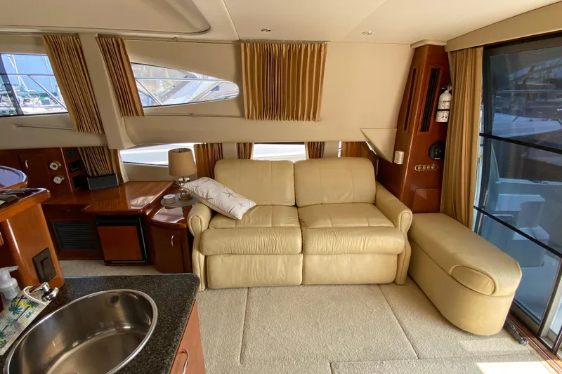 Slippin Out Yacht Photos Pics Luxurious interior of 2004 Carver 36 Super Sport yacht with beige leather sofa.