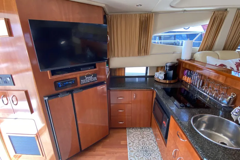 Slippin Out Yacht Photos Pics Interior of 2004 Carver 36 Super Sport yacht with kitchen and entertainment area.