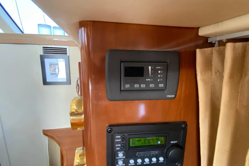 Slippin Out Yacht Photos Pics Control panel inside 2004 Carver 36 Super Sport yacht, featuring wood finish and modern electronics.