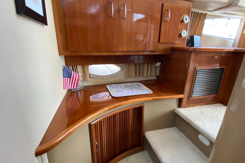 Slippin Out Yacht Photos Pics 2004 Carver 36 Super Sport interior with wooden cabinetry and American flag decor.