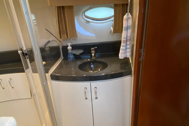 Slippin Out Yacht Photos Pics Bathroom interior of 2004 Carver 36 Super Sport yacht with sink and porthole window.