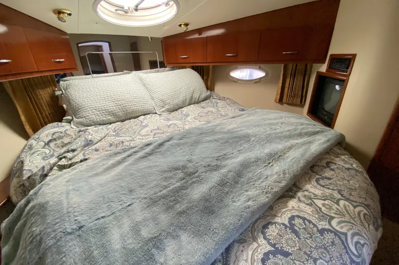 Slippin Out Yacht Photos Pics Luxurious bedroom interior of 2004 Carver 36 Super Sport yacht with cozy bedding.